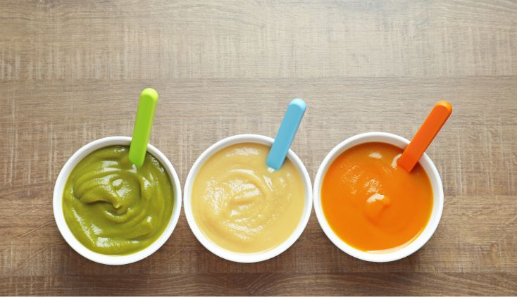 Three bowls of baby puree food.
