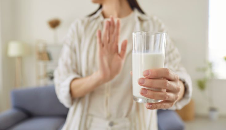 A woman holding a glass of milk.